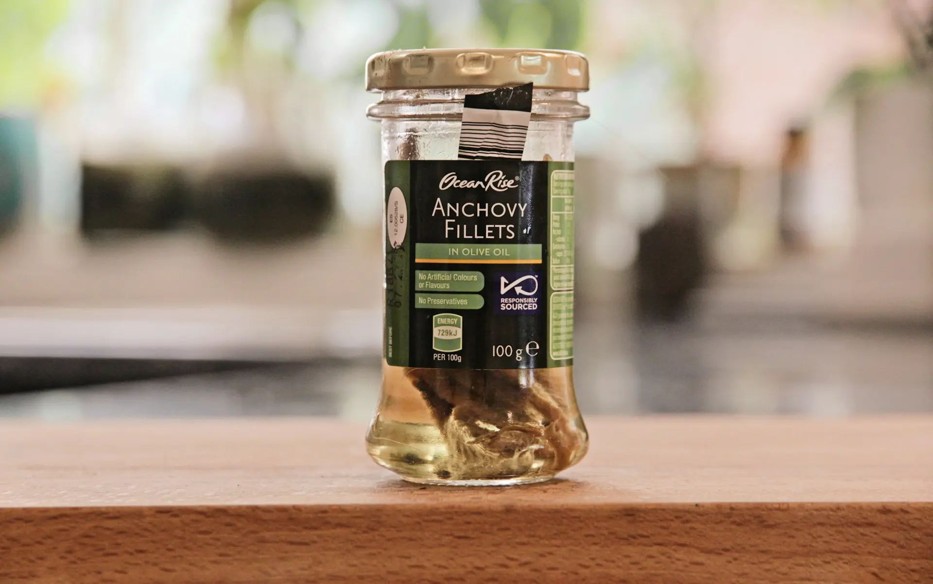 a jar of pickles sitting on top of a wooden table